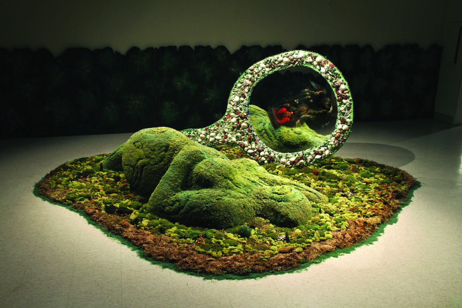 Amalia Mesa-Bains, Cihuateotl with Mirror in Private Landscapes and Public Territories, 1998-2011. Mixed media installation including painted and mirrored armoire, found objects, moss, dried flowers, faux topiaries, family photographs, miniature jeweled trees, painted wooden hedges; 180 in. diameter. Courtesy of the artist and Rena Bransten Gallery, San Francisco. Photo: Michael Karibian.